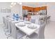 Bright dining room features a large table with seating for 10+, perfect for entertaining at 4498 Monado Dr, Kissimmee, FL 34746