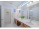 Double vanity bathroom with a large mirror and walk-in shower at 4498 Monado Dr, Kissimmee, FL 34746