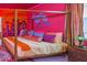 A themed bedroom with a large gold canopy bed and colorful decor at 4498 Monado Dr, Kissimmee, FL 34746