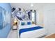 A bedroom with a large bed, blue color scheme, and accent wall at 4498 Monado Dr, Kissimmee, FL 34746