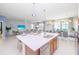 Open concept kitchen with large island, stainless steel appliances, and dining area at 4498 Monado Dr, Kissimmee, FL 34746