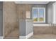 Bathroom with walk-in shower and separate soaking tub at 837 Desert Mountain Ct, Reunion, FL 34747