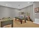 Game room featuring a pool table, foosball table, and seating area at 837 Desert Mountain Ct, Reunion, FL 34747