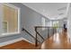 Elegant hallway with hardwood floors and a staircase at 837 Desert Mountain Ct, Reunion, FL 34747