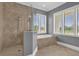 Spa-like bathroom with walk-in shower and soaking tub at 837 Desert Mountain Ct, Reunion, FL 34747