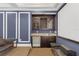 Home theater bar with wet bar, wine storage, and mini-fridge at 837 Desert Mountain Ct, Reunion, FL 34747