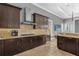 Modern kitchen with dark wood cabinets, stainless steel appliances, and granite countertops at 837 Desert Mountain Ct, Reunion, FL 34747