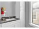 Small bathroom with a sink and white cabinets at 837 Desert Mountain Ct, Reunion, FL 34747