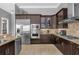 Modern kitchen with stainless steel appliances and granite countertops, great for entertaining at 837 Desert Mountain Ct, Reunion, FL 34747