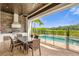 Outdoor kitchen with built-in grill, and a dining area overlooking the pool at 837 Desert Mountain Ct, Reunion, FL 34747