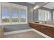 Elegant bathroom with double vanity and large window at 837 Desert Mountain Ct, Reunion, FL 34747