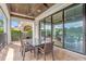 Covered patio with glass doors and outdoor dining table at 837 Desert Mountain Ct, Reunion, FL 34747