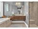 Bathroom with soaking tub, floating vanity, and glass shower at 837 Desert Mountain Ct, Reunion, FL 34747