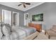 Bright bedroom with king-size bed, TV, and en-suite access at 837 Desert Mountain Ct, Reunion, FL 34747