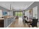 Open concept kitchen with stainless steel appliances and a large island with seating at 837 Desert Mountain Ct, Reunion, FL 34747