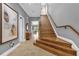 Bright entryway with hardwood staircase and art at 837 Desert Mountain Ct, Reunion, FL 34747