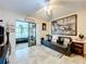 Cozy Gathering room featuring a sleeper sofa and access to a sunroom at 100 E Oak Terrace Dr # G1, Leesburg, FL 34748