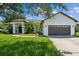 Single-story home with a two-car garage and solar panels at 4901 Culdesac Ct, St Cloud, FL 34772
