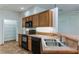 Kitchen with wood cabinets, double sink, and pantry at 4901 Culdesac Ct, St Cloud, FL 34772