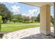 Relaxing patio with view of grassy lawn and trees at 7509 Seven Eagles Way, Reunion, FL 34747