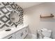 Stylish bathroom with a floating vanity, geometric tile, and a round mirror at 7509 Seven Eagles Way, Reunion, FL 34747