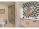 Clean bathroom with walk-in shower, toilet and floating vanity at 7509 Seven Eagles Way, Reunion, FL 34747
