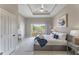 Bright main bedroom with king-size bed and sliding glass doors leading to balcony at 7509 Seven Eagles Way, Reunion, FL 34747