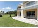 Ground level patio with adjacent grass and distant trees at 7509 Seven Eagles Way, Reunion, FL 34747