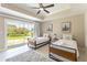 Bright bedroom with two twin beds and sliding glass doors to patio at 7509 Seven Eagles Way, Reunion, FL 34747