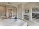 Main bedroom with king-size bed, en-suite bathroom, and access to the living room at 7509 Seven Eagles Way, Reunion, FL 34747