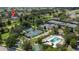Aerial view showing home, pool, and tennis courts at 7509 Seven Eagles Way, Reunion, FL 34747
