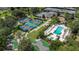 Aerial view of community amenities including pools, tennis, pickleball, and a putting green at 7509 Seven Eagles Way, Reunion, FL 34747