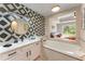 Elegant bathroom with a soaking tub and modern vanity at 7509 Seven Eagles Way, Reunion, FL 34747
