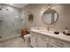 Modern bathroom with a walk-in shower, white cabinets, and geometric tile at 7509 Seven Eagles Way, Reunion, FL 34747