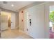 Bright entryway with white door, laundry closet, and stairs at 7509 Seven Eagles Way, Reunion, FL 34747
