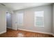 Well-lit bedroom featuring hardwood floors and a closet at 732 E Orange Ave, Eustis, FL 32726