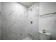 Clean shower with marble tile and glass enclosure at 732 E Orange Ave, Eustis, FL 32726