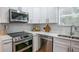 Stainless steel appliances and white shaker cabinets in kitchen at 732 E Orange Ave, Eustis, FL 32726