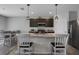 Kitchen with island, dark cabinets, and pendant lighting at 209 Sofia Ln, Lake Alfred, FL 33850