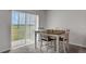 Small dining area with table and chairs near sliding door at 209 Sofia Ln, Lake Alfred, FL 33850