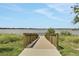 Scenic walkway leading to a peaceful lake view at 209 Sofia Ln, Lake Alfred, FL 33850