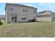 House with backyard, grassy area, and solar panels at 209 Sofia Ln, Lake Alfred, FL 33850
