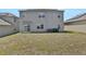 House with backyard, grassy area, and solar panels at 209 Sofia Ln, Lake Alfred, FL 33850