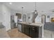 Modern kitchen with dark cabinets and island at 209 Sofia Ln, Lake Alfred, FL 33850