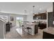 Open kitchen features an island with seating and modern appliances at 209 Sofia Ln, Lake Alfred, FL 33850