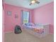 Pink bedroom with a daybed and plenty of natural light at 209 Sofia Ln, Lake Alfred, FL 33850