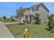 Two-story house with gray siding, red shutters, and landscaping at 209 Sofia Ln, Lake Alfred, FL 33850