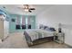 Spacious main bedroom with a king-size bed and ceiling fan at 209 Sofia Ln, Lake Alfred, FL 33850