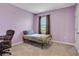 Light purple bedroom with a twin-size bed and an office chair at 209 Sofia Ln, Lake Alfred, FL 33850