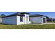 Newly built home with a white exterior, black accents, and a two-car garage at 1300 Hillsborough Ct, Kissimmee, FL 34759